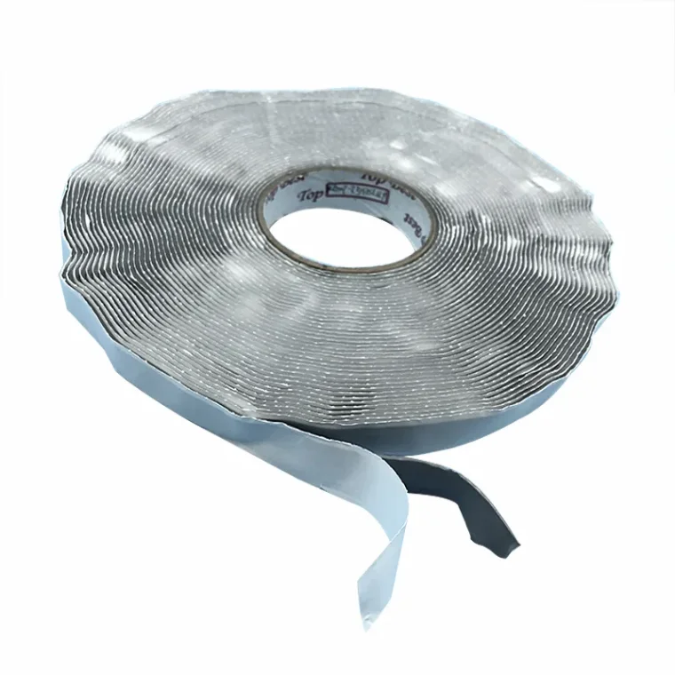 Application of gray butyl tape on metal roof